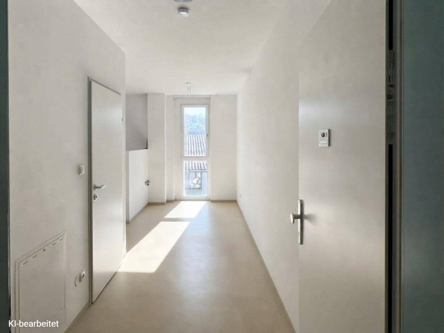 Heller, leerer Flur mit weiß gestrichenen Wänden und einem Fenster am Ende.
