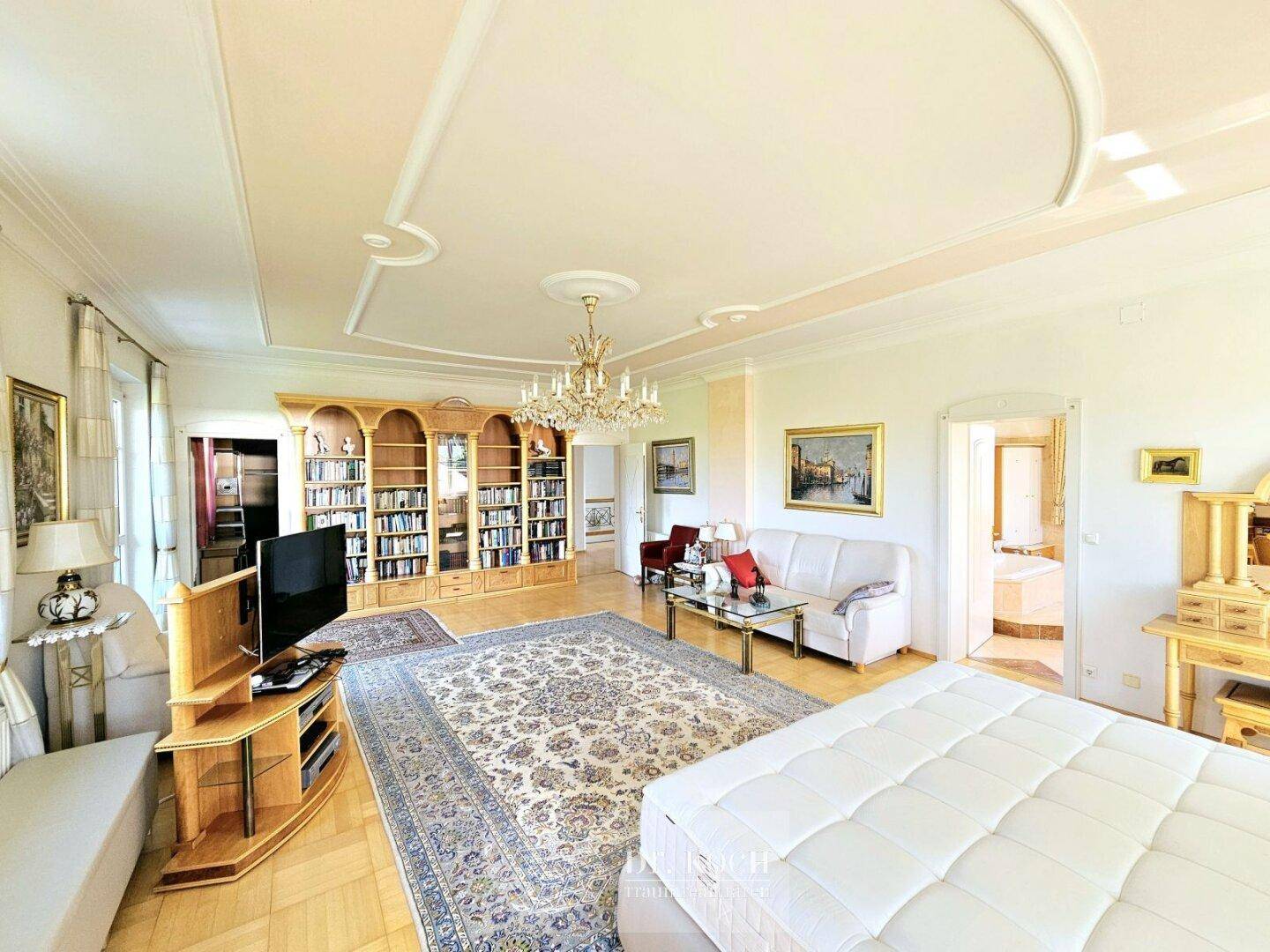 Großes Schlafzimmer mit Parkettboden, Bücherregal und klassischer Einrichtung, bietet vielseitige Nutzung.