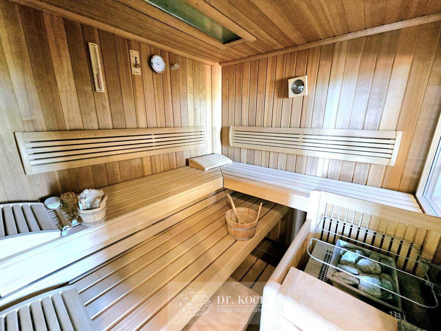 Private Sauna mit Holzverkleidung und Bänken, ideal zur Entspannung und Erholung.