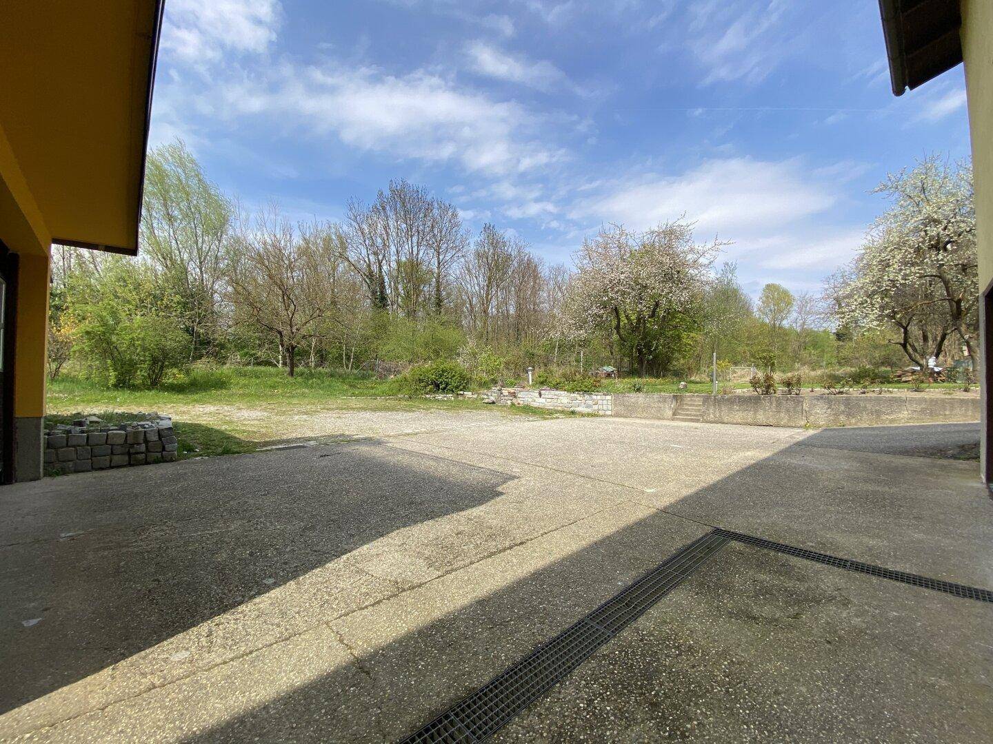 Große gepflasterte Fläche, ideal als Parkplatz oder Hof.