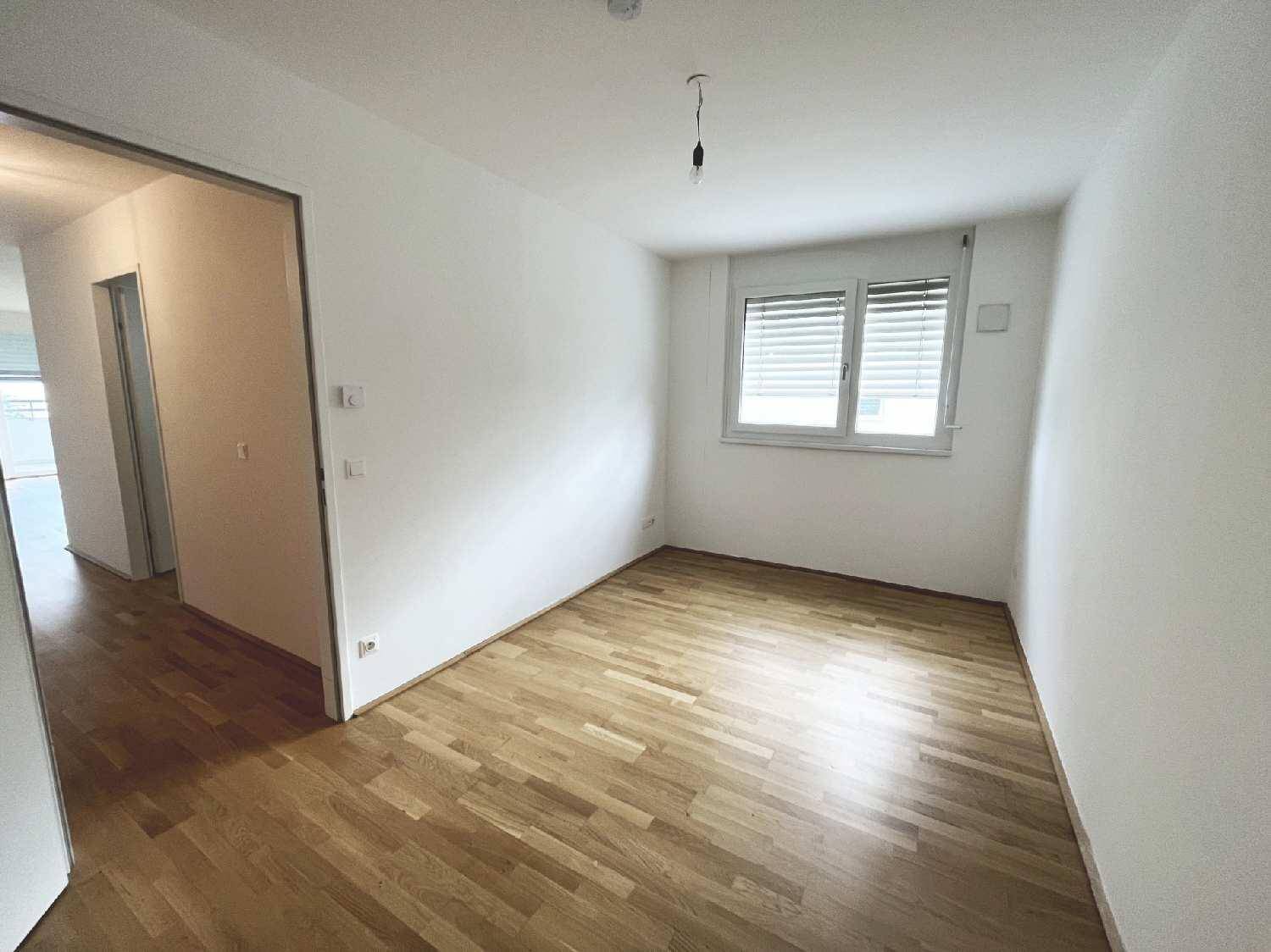 Helles Zimmer mit Parkettboden und Fenster, ideal als Schlaf- oder Arbeitszimmer.