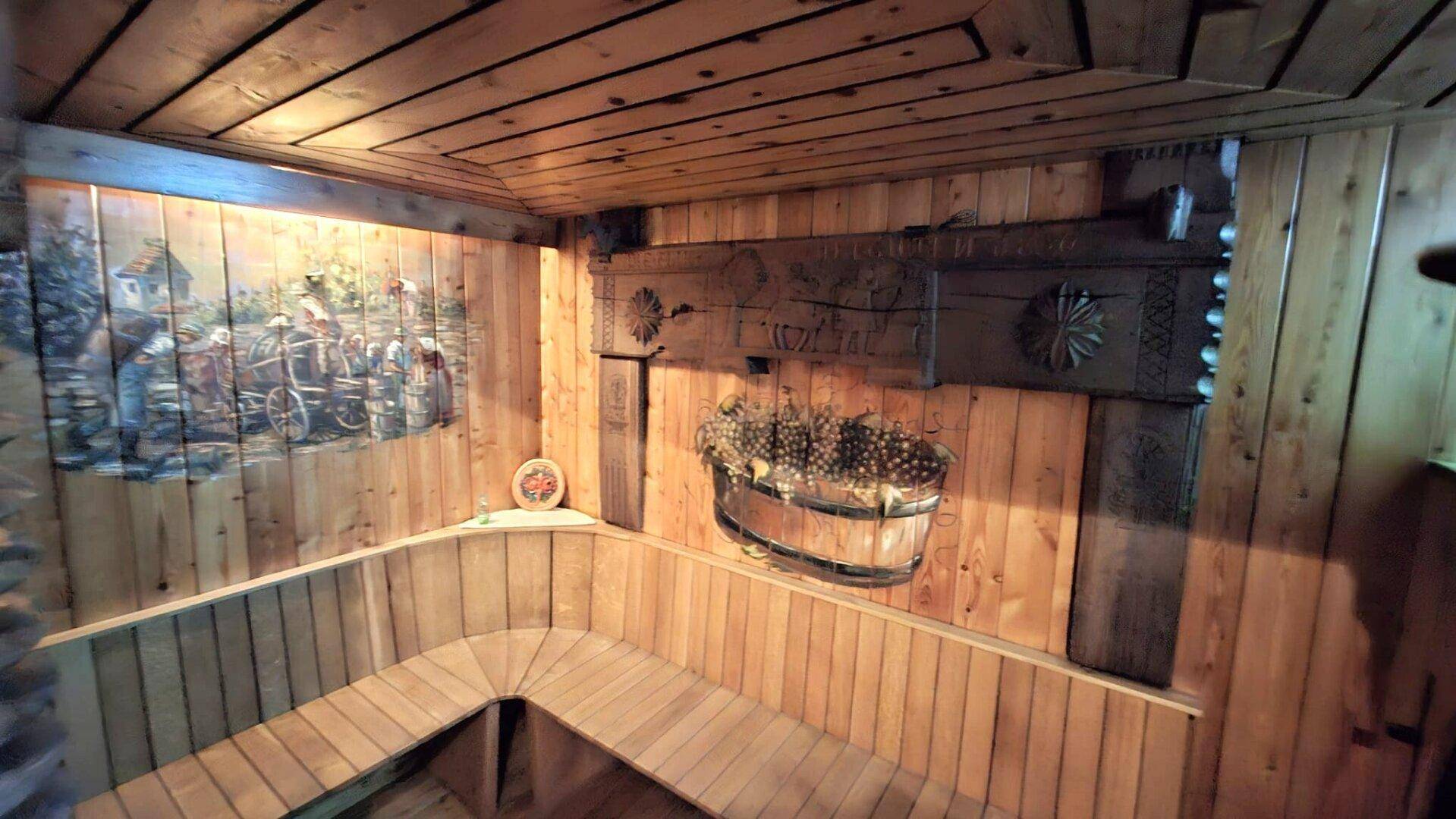 Gemütlicher Holzraum mit Eckbänken und traditionellen Dekorationen an den Wänden.