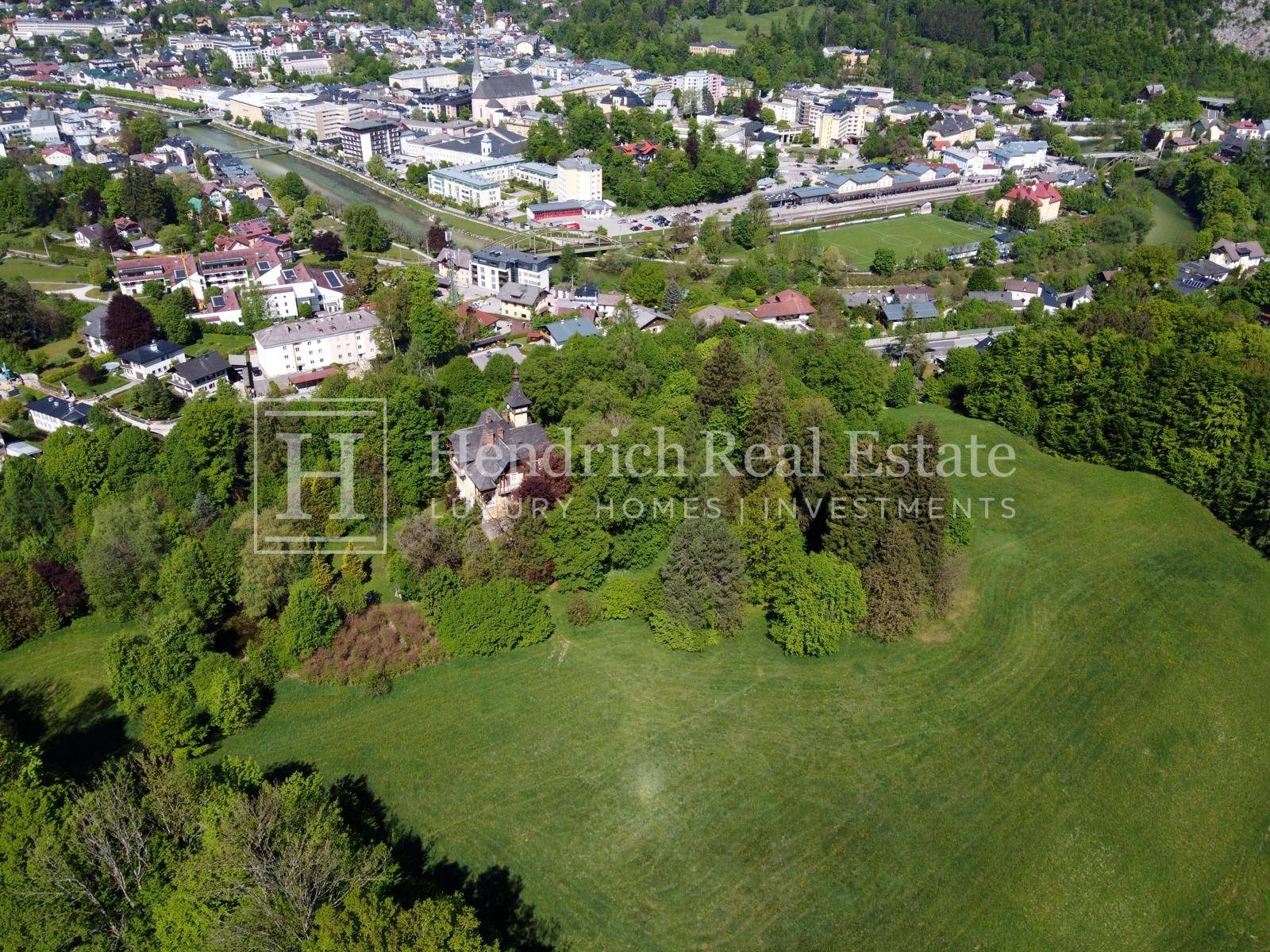 Luftaufnahme der Villa inmitten einer grünen Landschaft mit Blick auf die umliegende Stadt.