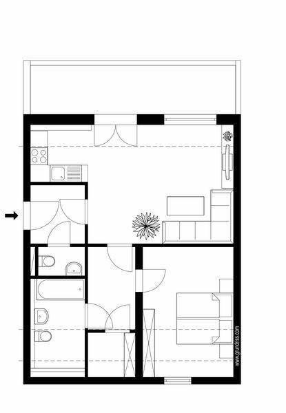 Grundriss einer Wohnung mit offenem Wohnbereich, Schlafzimmer und Bad.