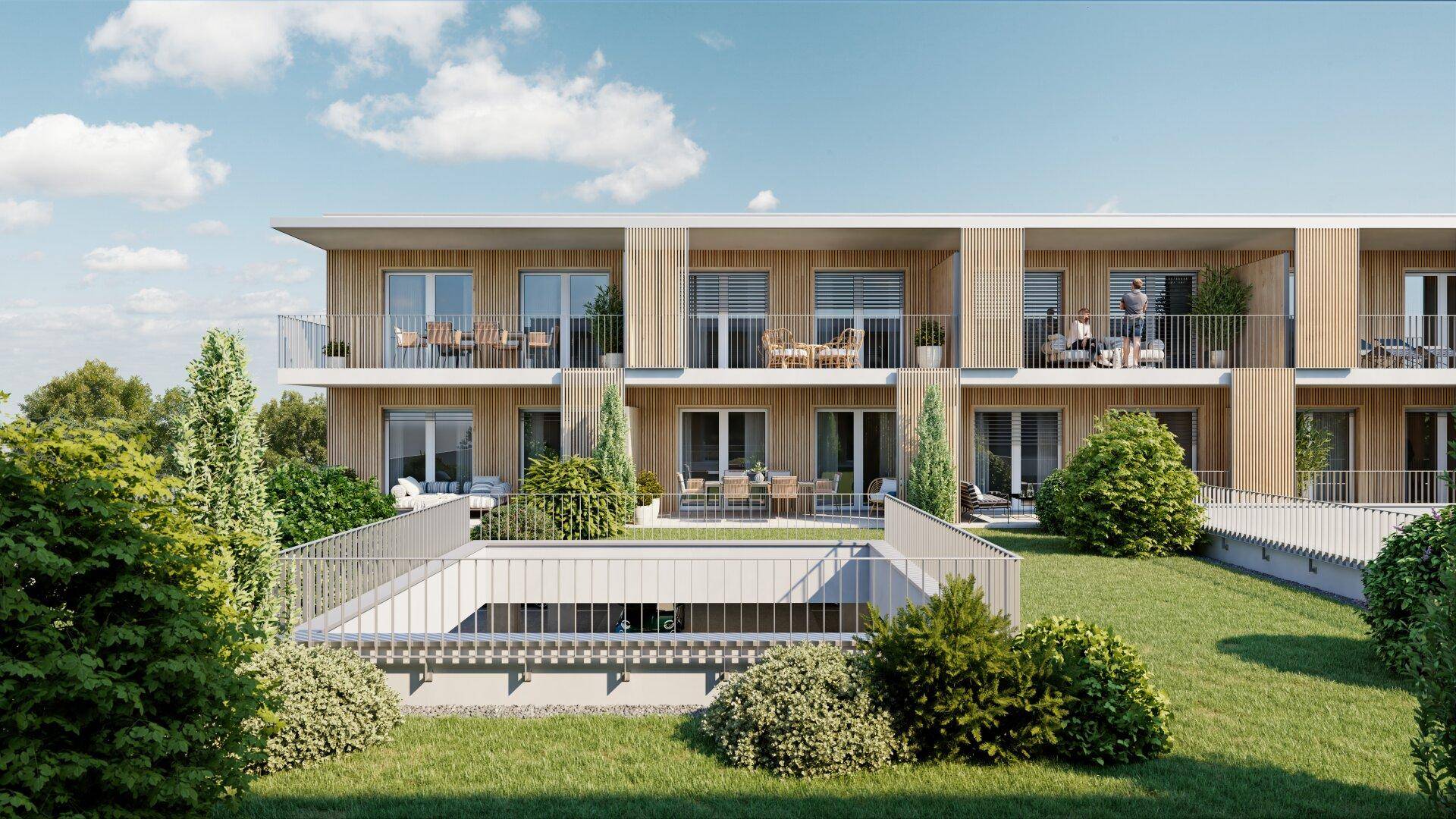 Fassade des modernen Wohngebäudes mit Balkonen und Zugang zur Tiefgarage im Vordergrund.