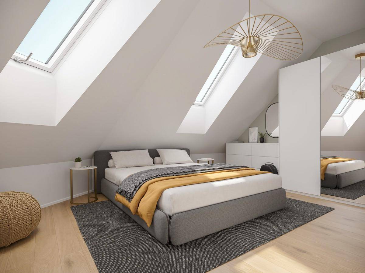 Modernes Schlafzimmer im Dachgeschoss mit schrägen Wänden und Dachfenstern.