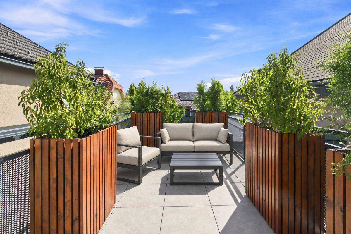 Gemütliche Dachterrasse mit modernen Gartenmöbeln und Blick auf die Umgebung.