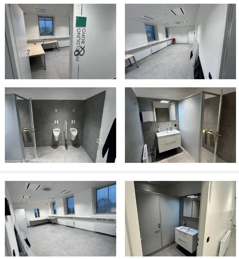 Moderne Büroräume mit Fliesenböden und stilvollen Badezimmern, ausgestattet mit Urinalen, Duschen und Fenstern.