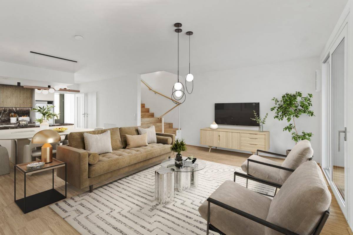 Modernes Wohnzimmer mit beigem Sofa, Holzboden und offener Küche im Hintergrund.