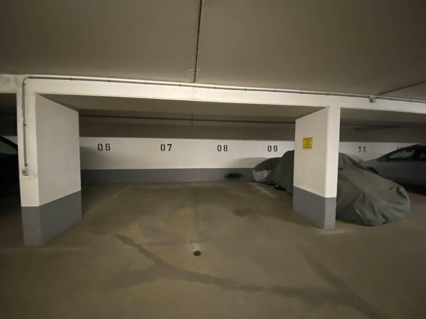 Leerer Stellplatz in einer Tiefgarage, gekennzeichnet mit den Nummern 06 bis 09.