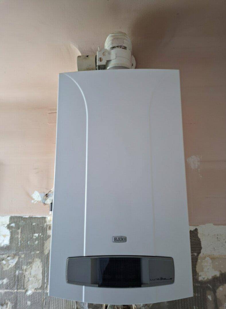 Nahaufnahme einer Baxi Gastherme an einer Wand in Renovierung.