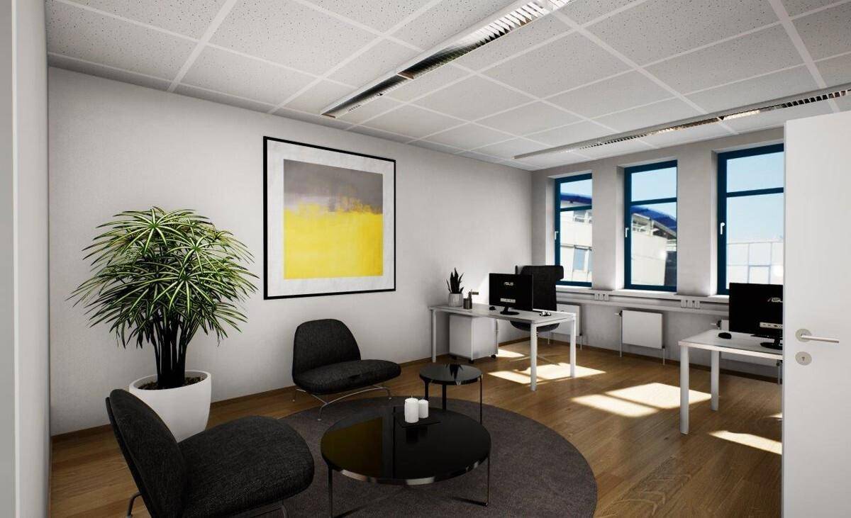 Modernes Büro mit Holzboden, Arbeitsplätzen und einer kleinen Sitzecke für Besprechungen.
