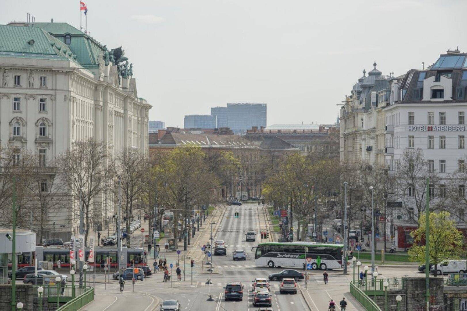 Weitläufiger Stadtblick mit belebter Straße und historischen Gebäuden.