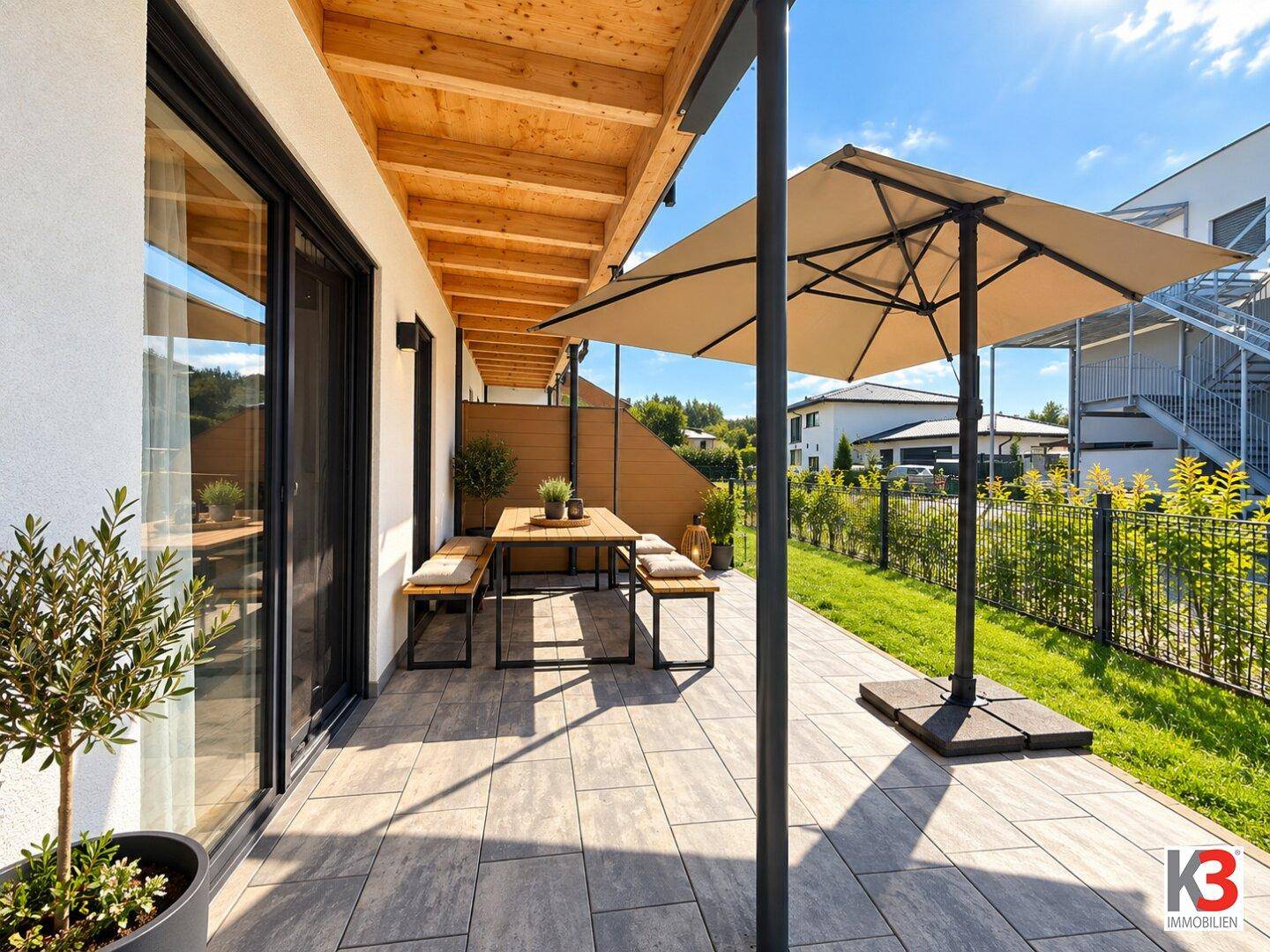 Geräumige Terrasse mit Holzdach, modernen Fliesen und Sitzgelegenheiten im Freien.