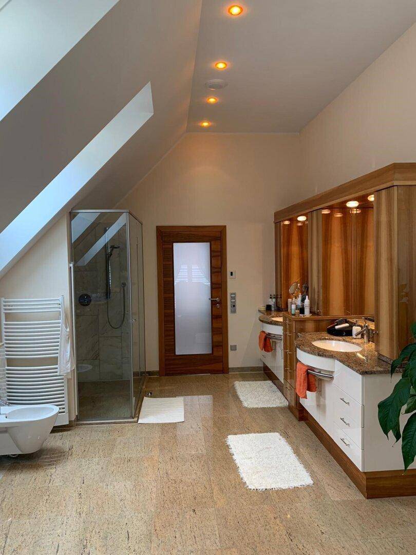 Modernes Badezimmer mit Dachschräge, Doppelwaschbecken, begehbarer Dusche und Bidet.