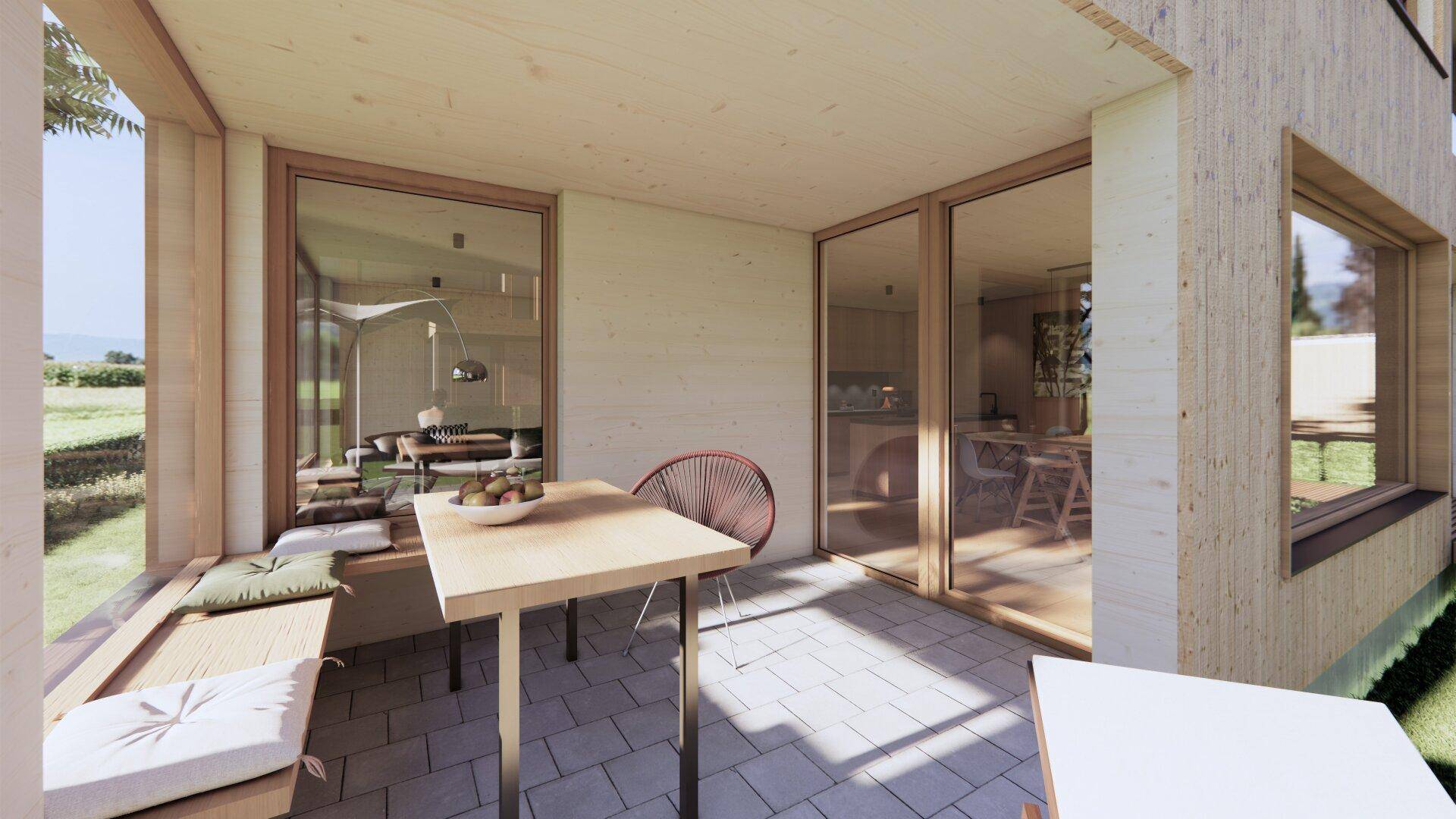 Möblierte Terrasse mit Fliesenboden und Blick ins Grüne, zugänglich vom Wohnbereich.