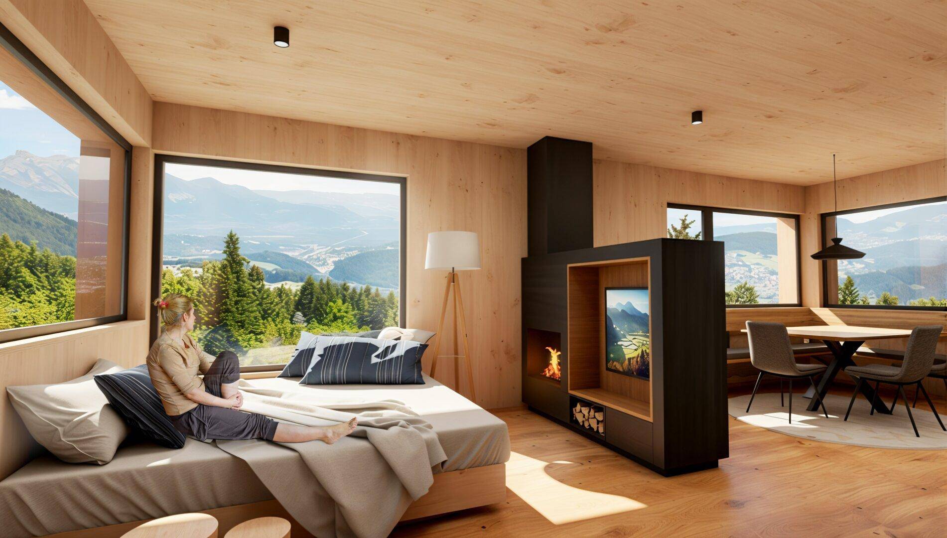 Heller Wohn-Essbereich mit Holzböden, Kamin und weitem Bergblick durch große Fenster.