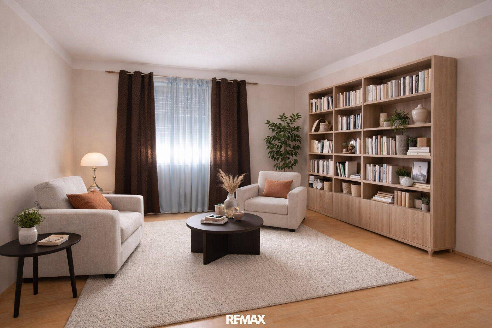 Modern eingerichtetes Wohnzimmer mit Bücherregal, bequemen Sofas und Teppichboden.