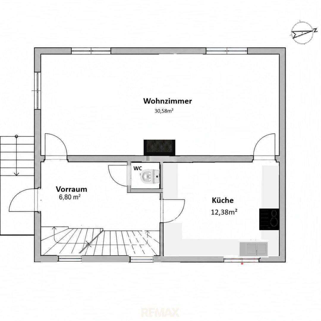 Grundriss zeigt Wohnzimmer, Küche, Vorraum und separates WC mit Kamin im Wohnbereich.