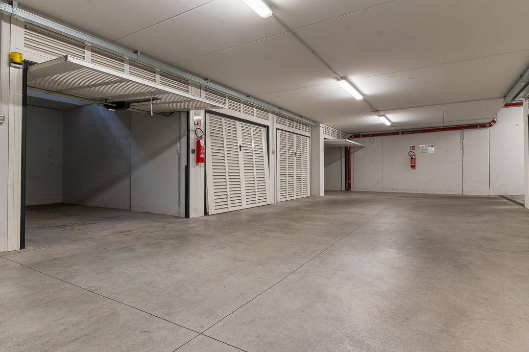 Geräumige Tiefgarage mit mehreren Stellplätzen und Rolltoren.