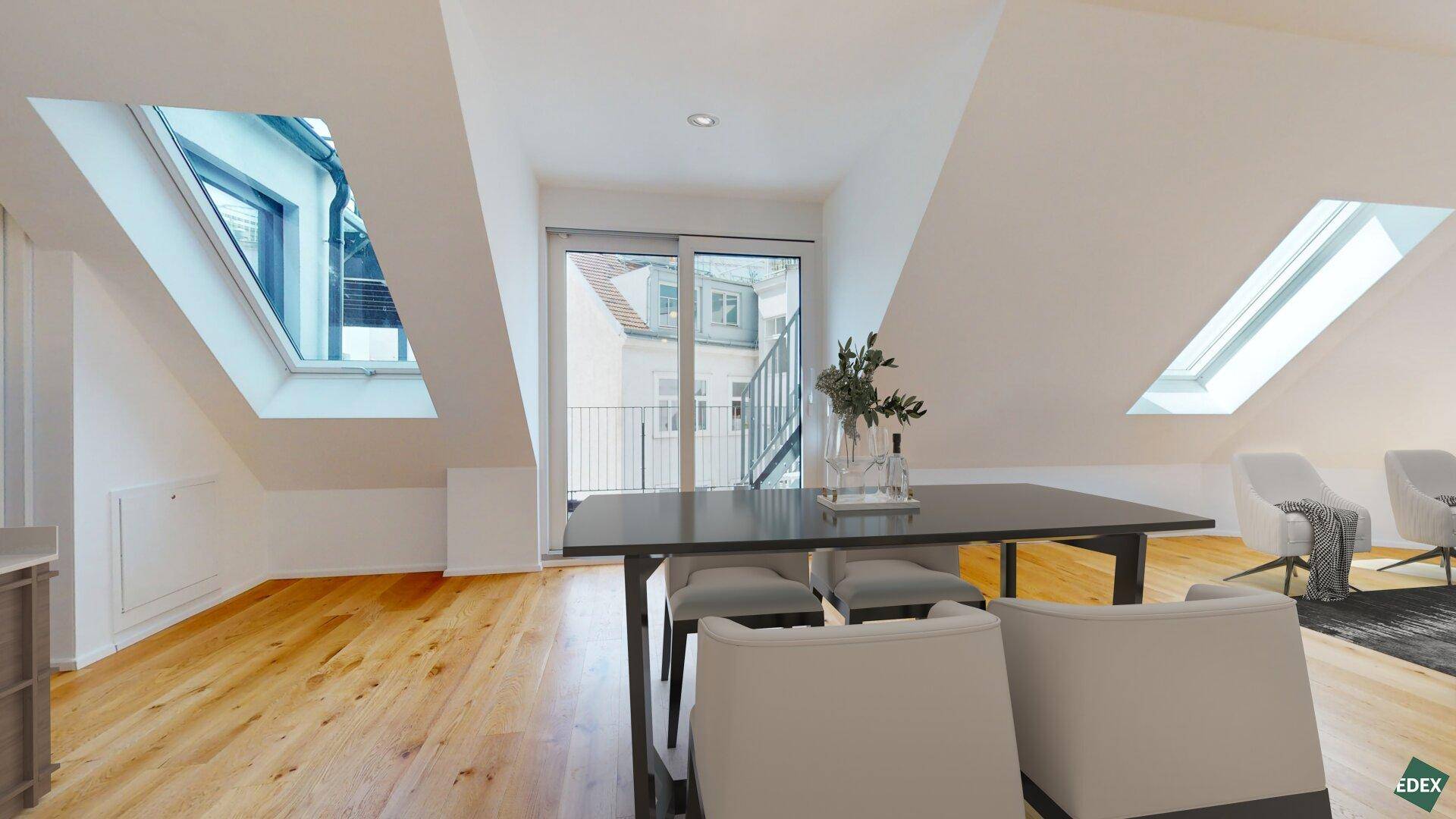 Moderner Essbereich im Dachgeschoss mit Holzboden, Dachfenstern und Zugang zu einem Balkon.