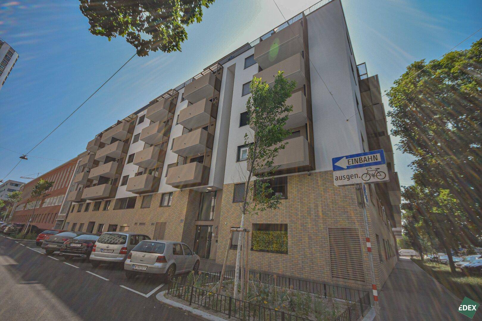 Moderne Wohnanlage mit zahlreichen Balkonen und zeitgenössischer Architektur in urbaner Umgebung.