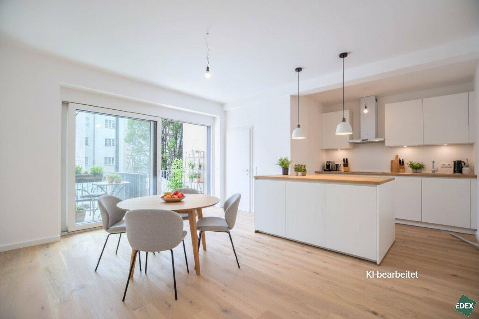 Moderne offene Küche mit weißer Kücheninsel und Essbereich, direktem Zugang zum Balkon.