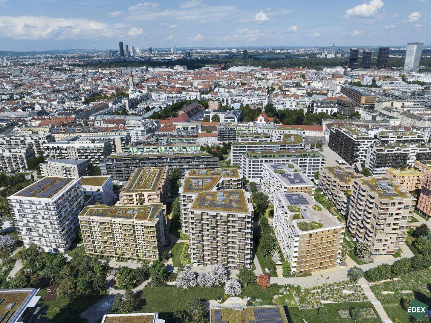 Luftaufnahme einer modernen Wohnsiedlung mit begrünten Dächern in städtischer Umgebung.