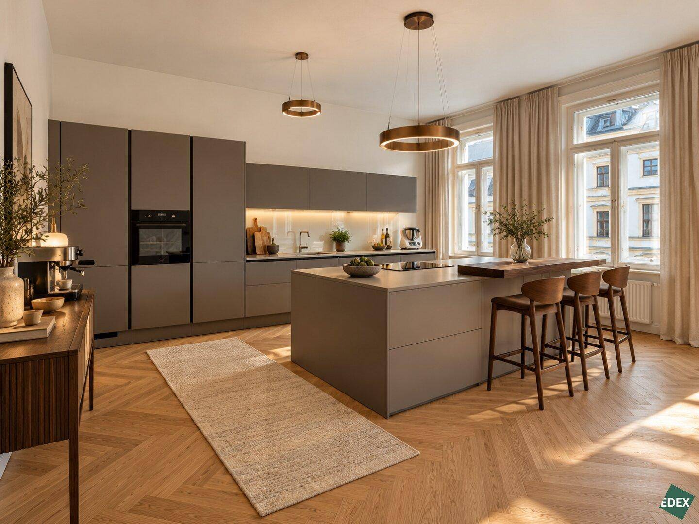 Moderne Küche mit Kücheninsel, integrierten Geräten und stilvoller Beleuchtung im offenen Wohnbereich.