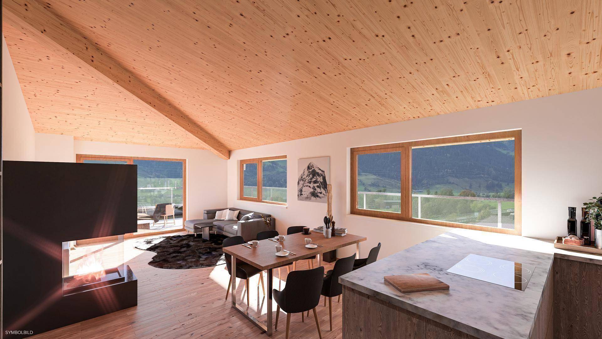 Geräumiger Wohn-Essbereich mit Holzdachschräge, modernem Kamin und weitem Bergblick.