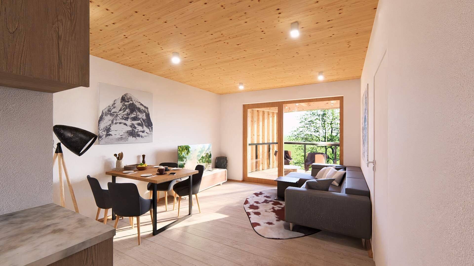 Gemütlicher Wohn-Essbereich mit Holzbalkendecke, Parkettboden und Blick ins Grüne.