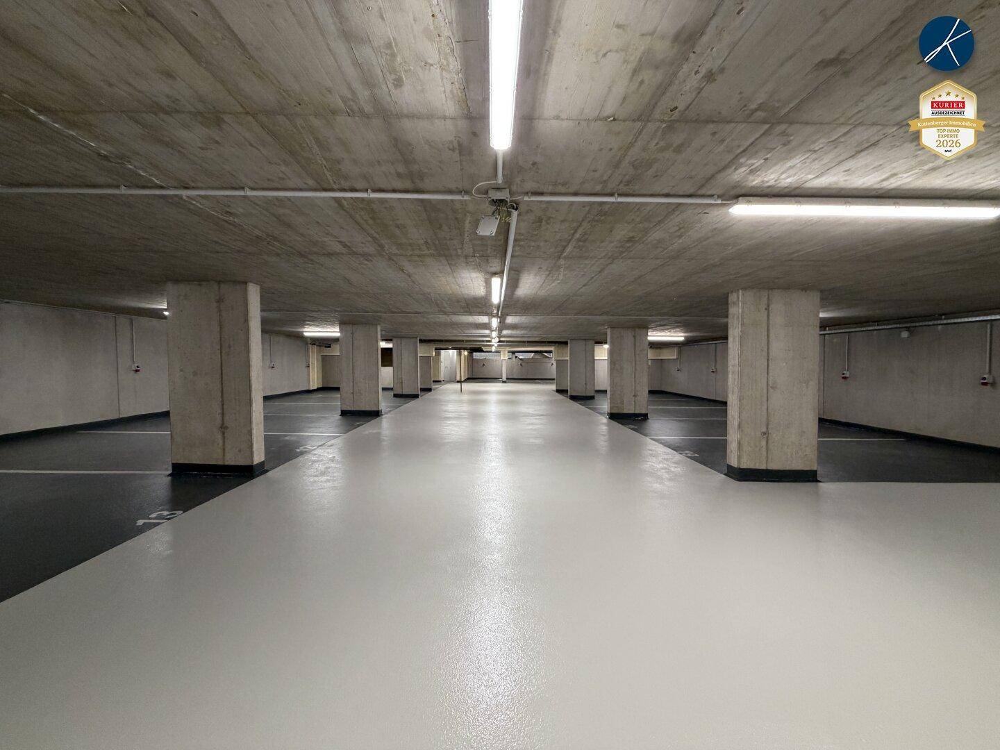 Geräumige Tiefgarage mit Betonpfeilern und markierten Parkplätzen.