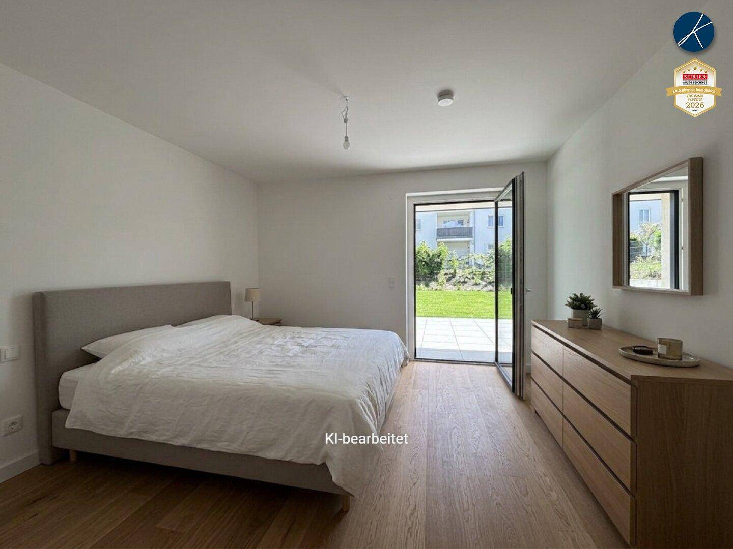 Helles Schlafzimmer mit Holzboden, modernem Bett und Zugang zu einer Terrasse und dem Garten.