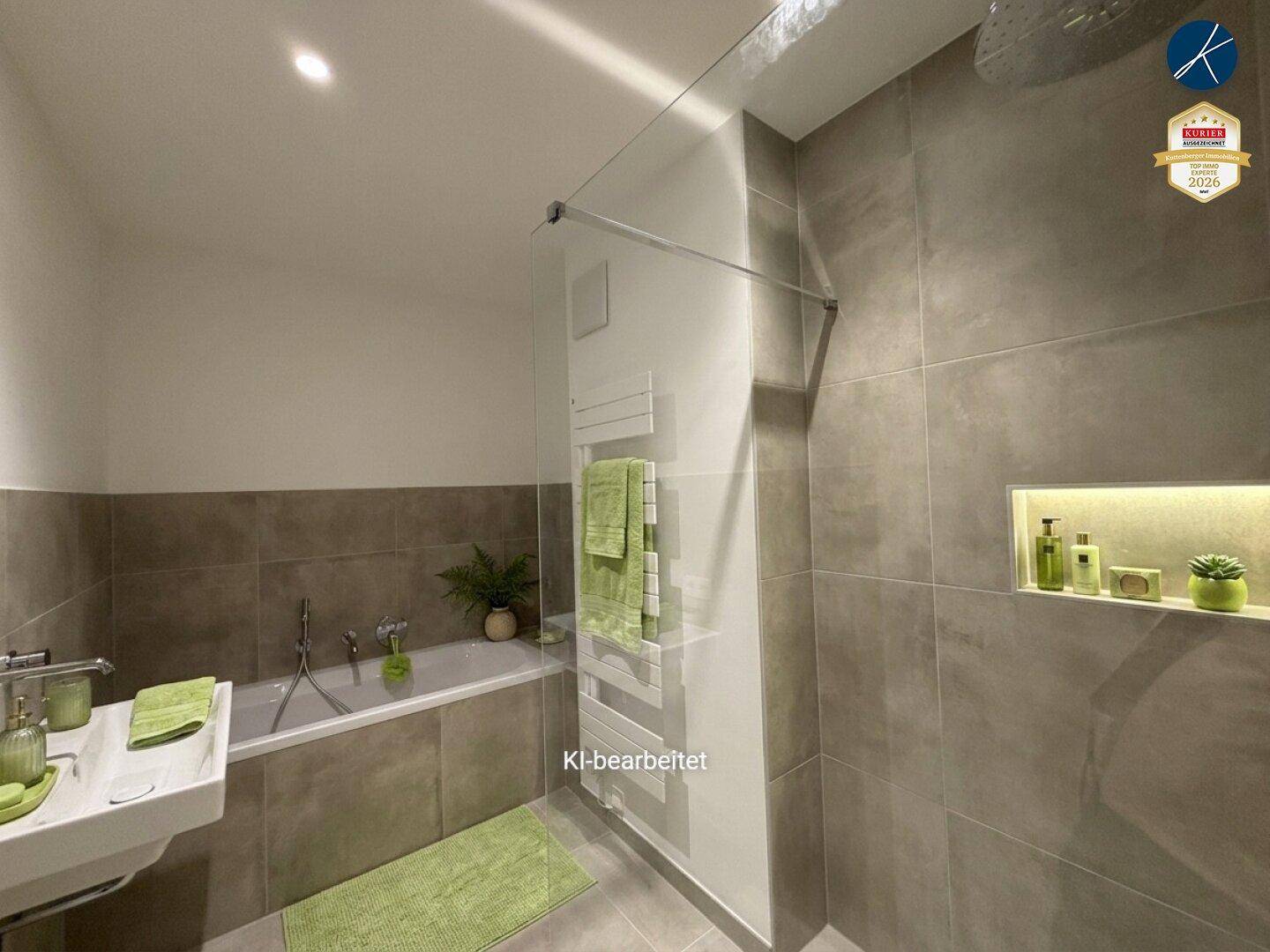 Modernes Badezimmer mit Badewanne, begehbarer Dusche, beheiztem Handtuchhalter und grauen Fliesen.