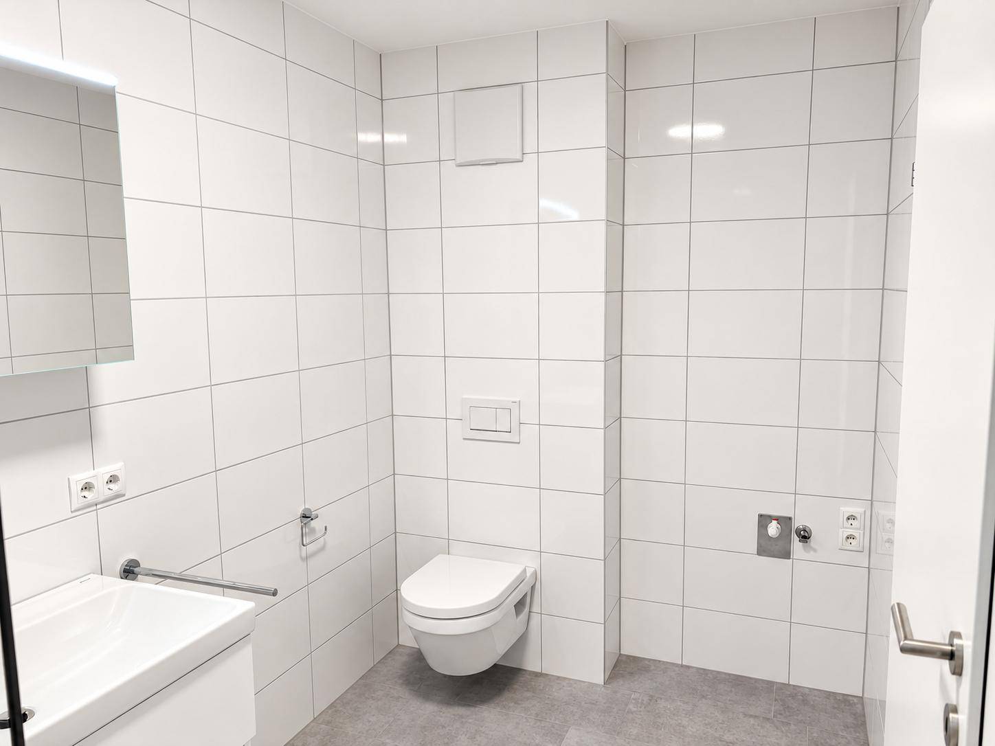 Modernes Badezimmer mit wandhängendem WC, Waschtisch und weißen Fliesen.