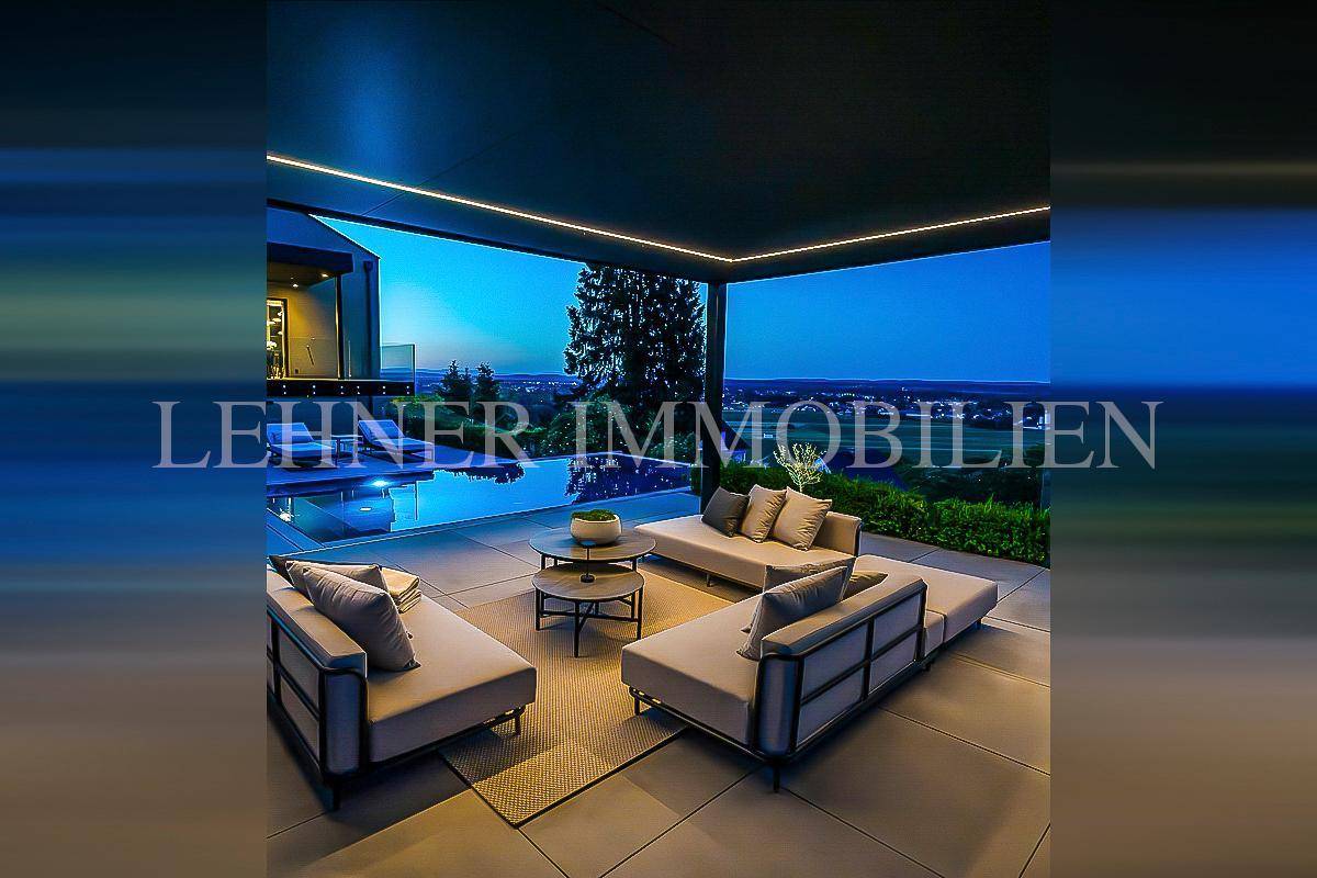 Elegante Terrasse mit bequemen Lounge-Möbeln und weitem Blick über die Landschaft.
