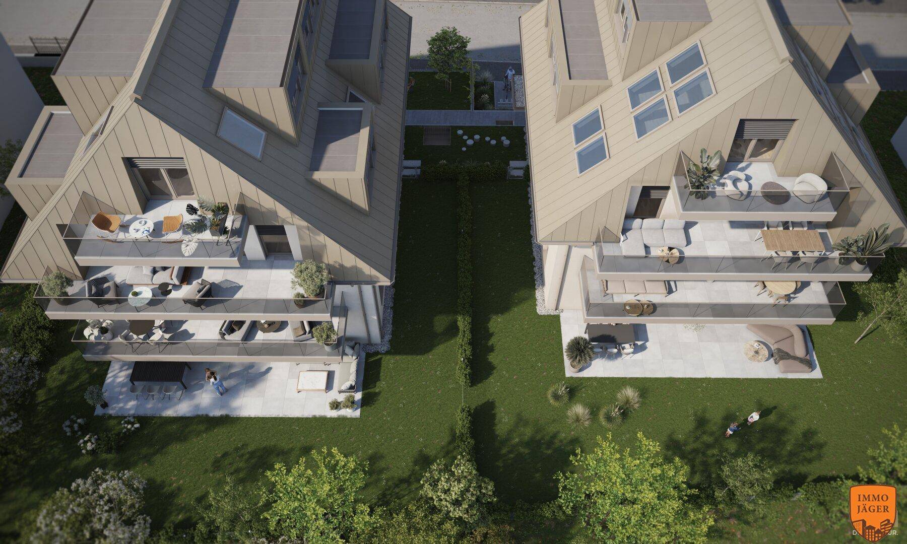Vogelperspektive zweier moderner Wohngebäude mit gemeinsamer Grünfläche und Terrassen.