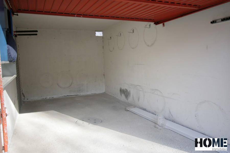 Leere Garage mit Betonboden und einfachen Wänden, bereit zur Nutzung als Stellplatz.