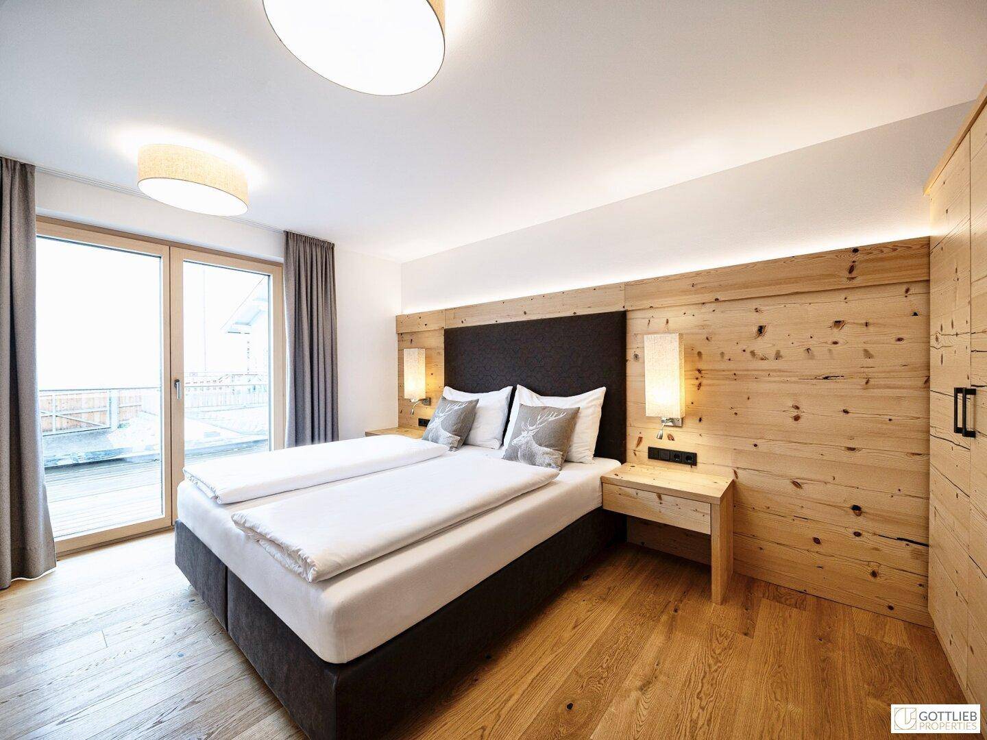 Komfortables Schlafzimmer mit Doppelbett und direktem Zugang zu einem Außenbereich durch eine Schiebetür.