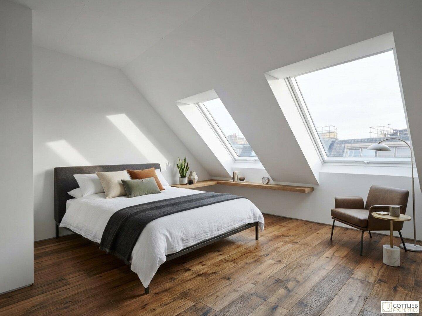 Helles Schlafzimmer im Dachgeschoss mit Holzboden, Doppelbett und großen Dachfenstern.