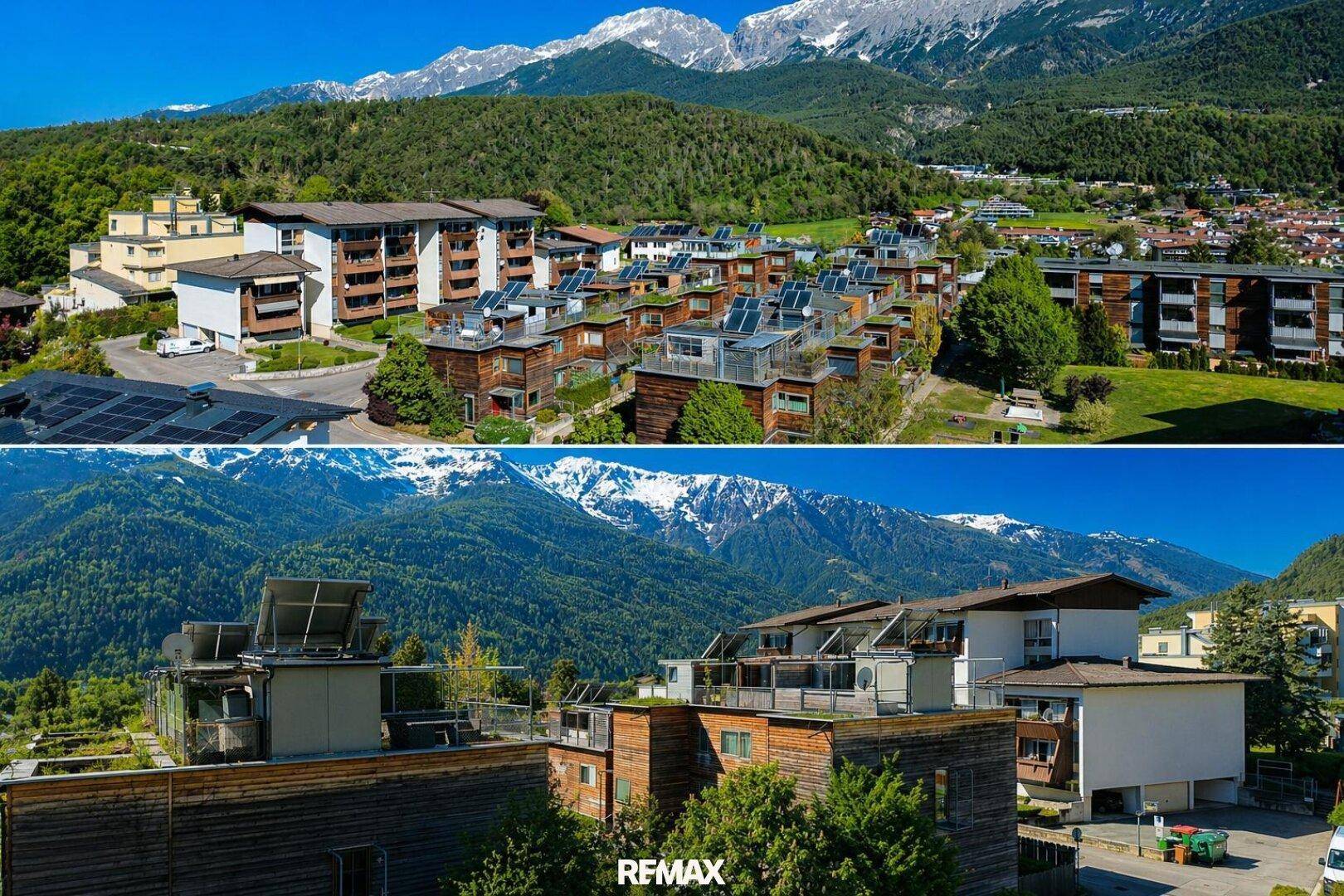Panoramablick auf die Wohnanlage mit Bergblick und Solaranlagen auf den Dächern.