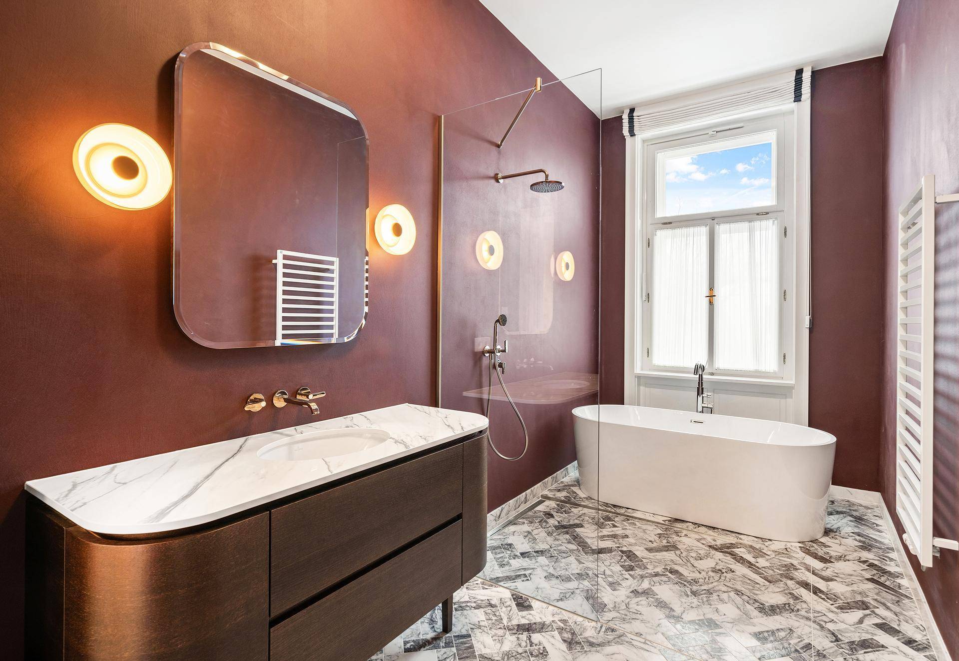 Elegantes Badezimmer mit freistehender Badewanne, großer Dusche und Marmorwaschtisch.