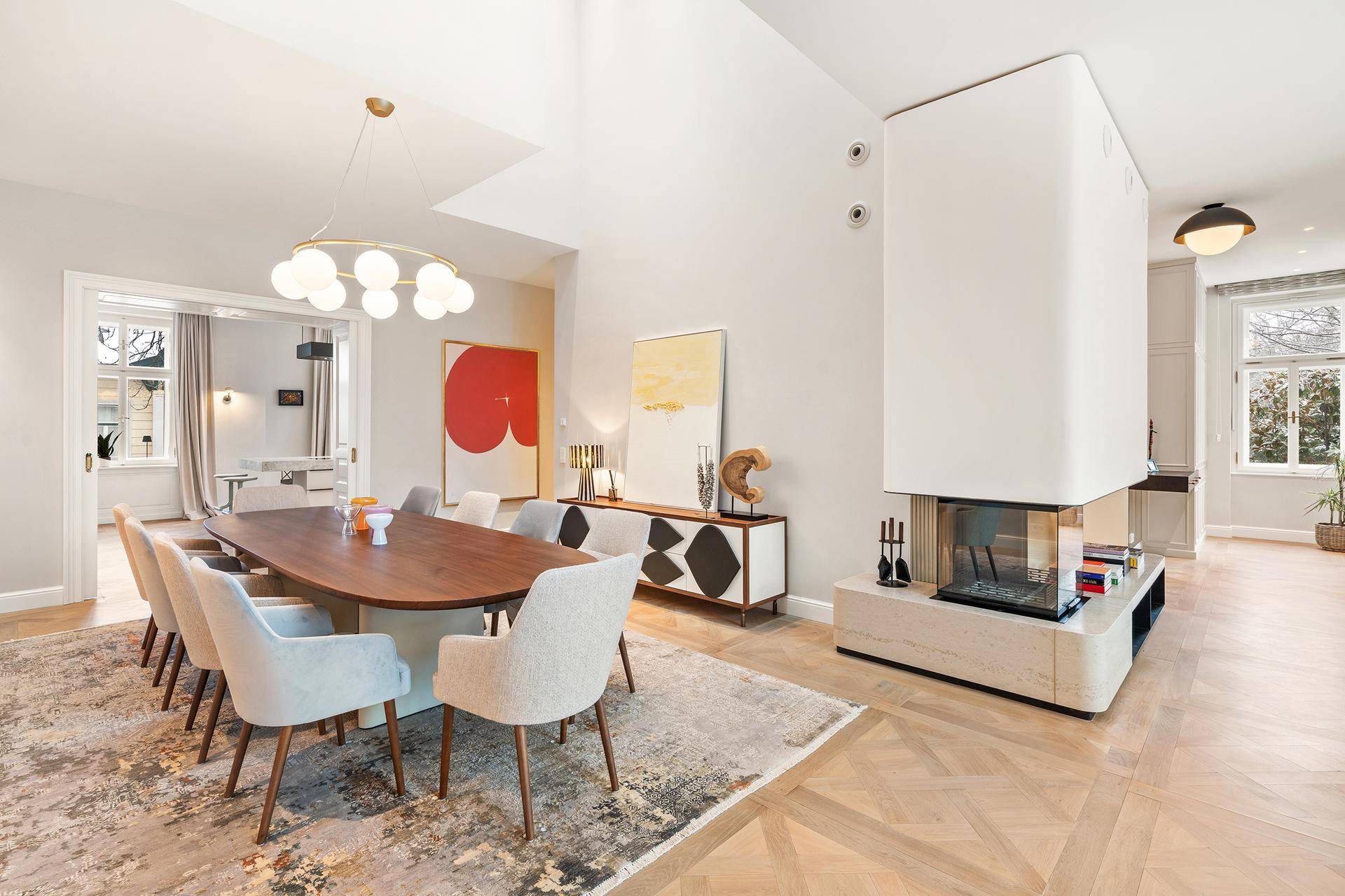 Eleganter Essbereich mit großem Holztisch, modernen Stühlen und integriertem Kamin.