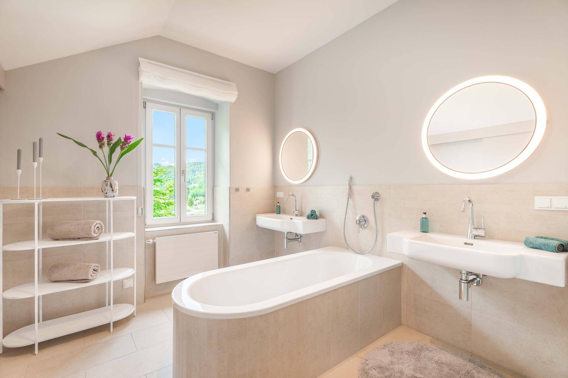 Modernes Badezimmer mit Badewanne, Doppelwaschbecken und Fenster für natürliches Licht.