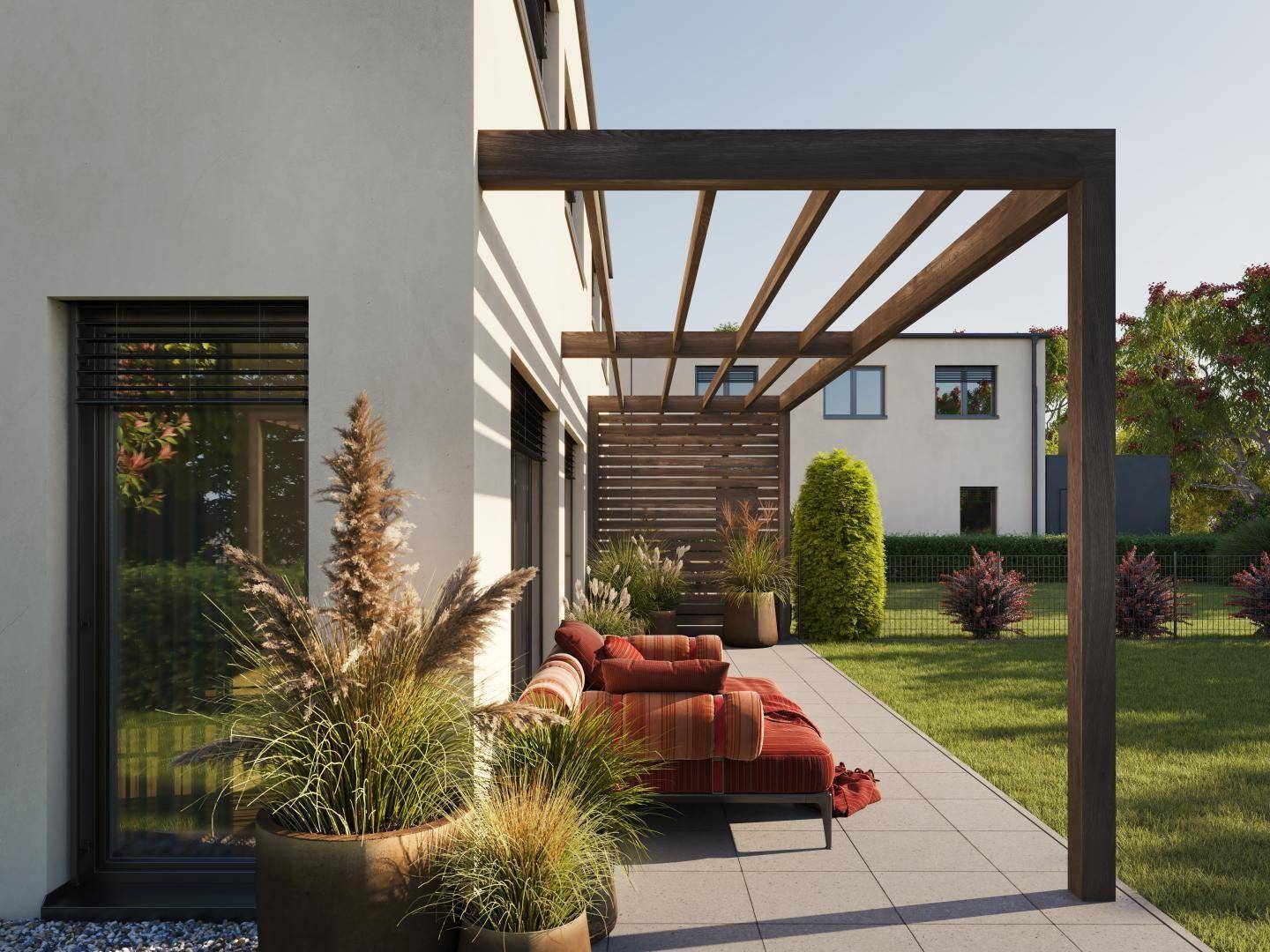 Detailansicht der Terrasse mit bequemen Loungemöbeln und dekorativen Pflanzen im Gartenbereich.
