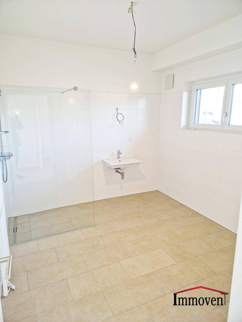 Modernes Badezimmer mit begehbarer Dusche, Einzelwaschbecken und Fenster für Tageslicht.