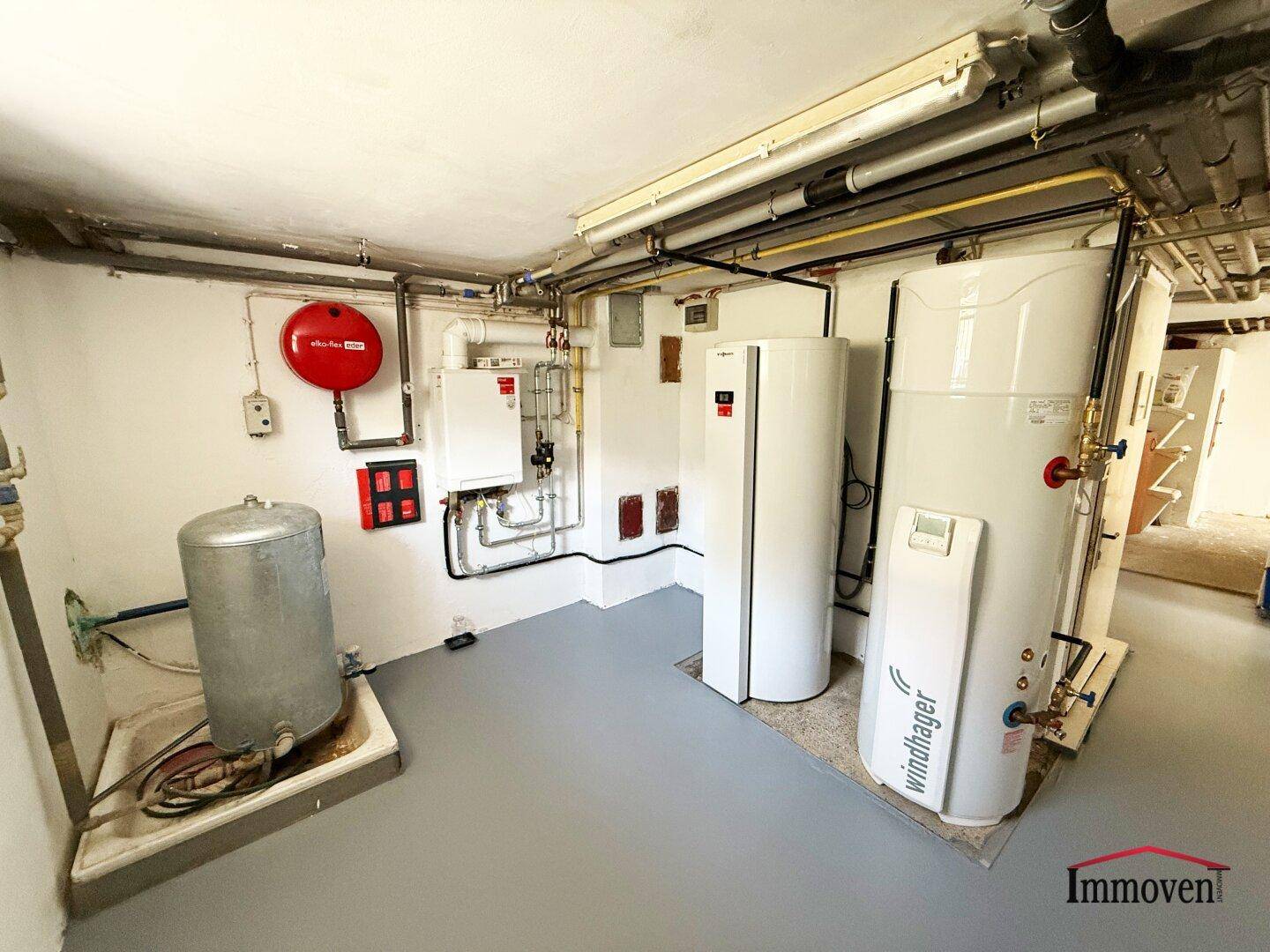 Funktionaler Heizraum im Keller mit modernen Heizungsanlagen und Warmwasserspeichern.