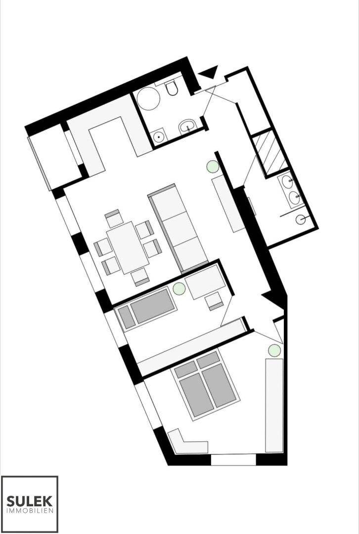 Grundriss einer Wohnung mit offenem Wohnbereich, zwei Schlafzimmern und zwei Bädern.
