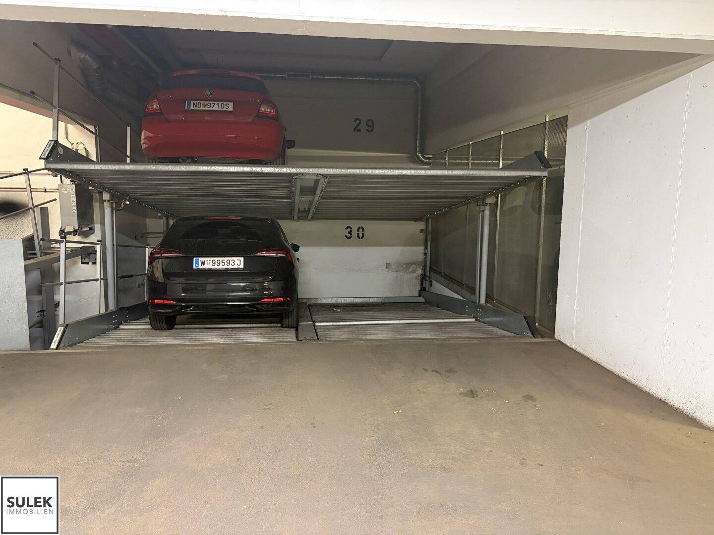 Tiefgarage mit Doppelparker-System für zwei Fahrzeuge auf übereinanderliegenden Plattformen.