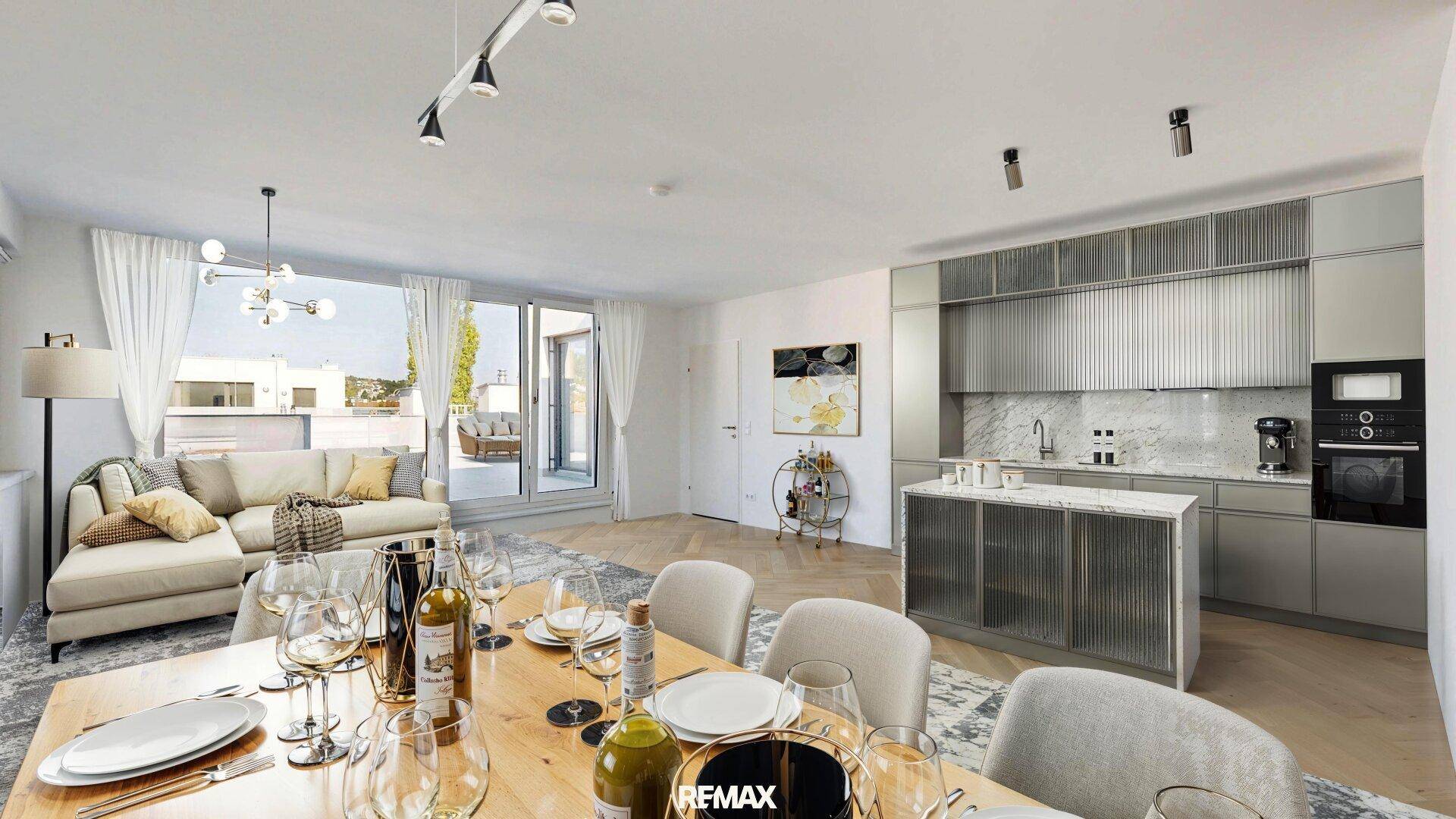 Offener Wohn-Essbereich mit moderner Küche, Holzboden und Zugang zu einer Terrasse.